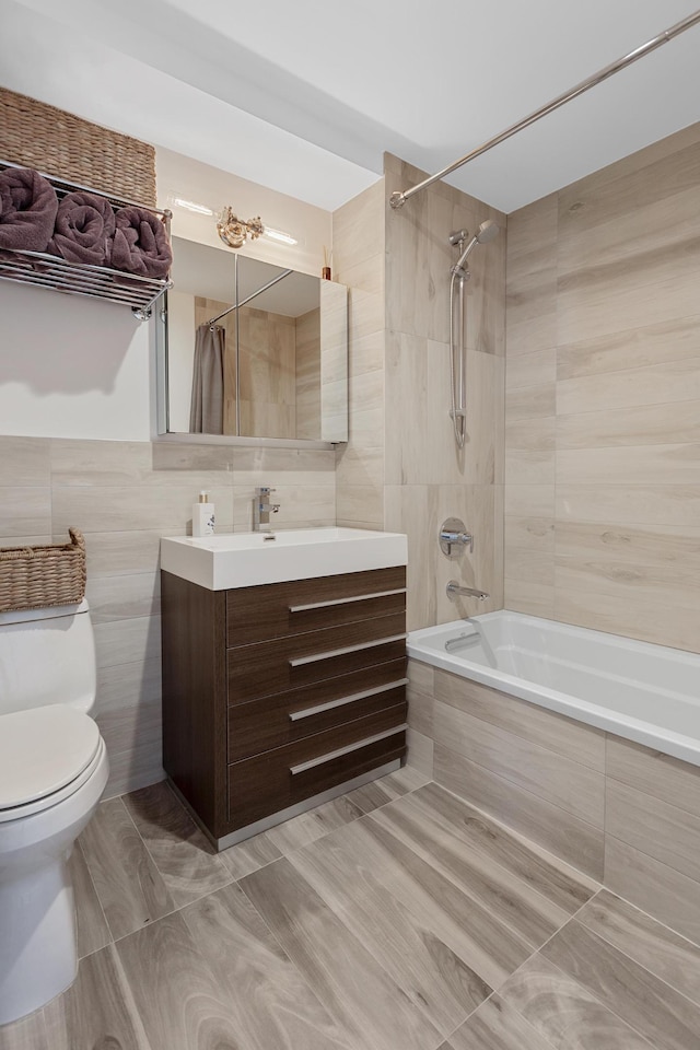 47-28 11th St Unit 6-C, New York City, NY 11101 - full bath with tile walls, tiled shower / bath combo, toilet, and vanity