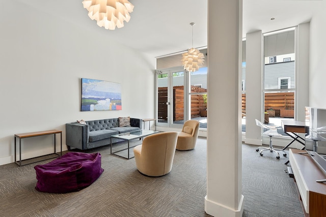 47-28 11th St Unit 6-C, New York City, NY 11101 - living room with a chandelier, carpet flooring, a desk, and baseboards
