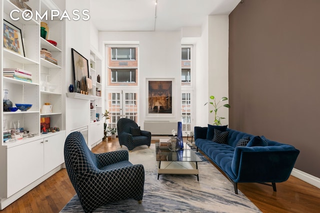 living area featuring wood finished floors and baseboards
