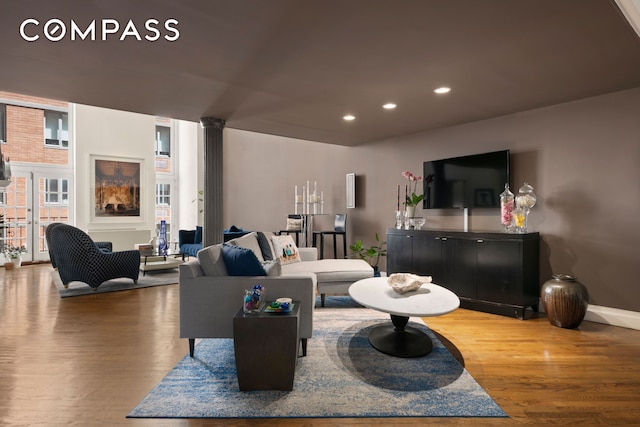 121 W 20th St Unit 2D, New York City, NY 10011 - living area with ornate columns, wood finished floors, recessed lighting, and healthy amount of natural light