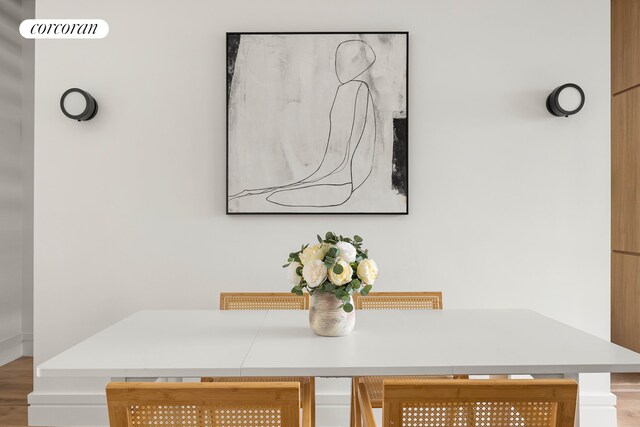 dining space with wood finished floors