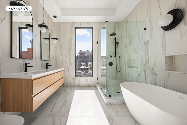 full bathroom featuring a sink, a marble finish shower, marble finish floor, a tray ceiling, and double vanity
