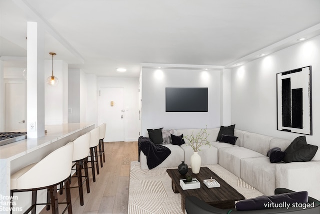 living room featuring light wood-type flooring and recessed lighting