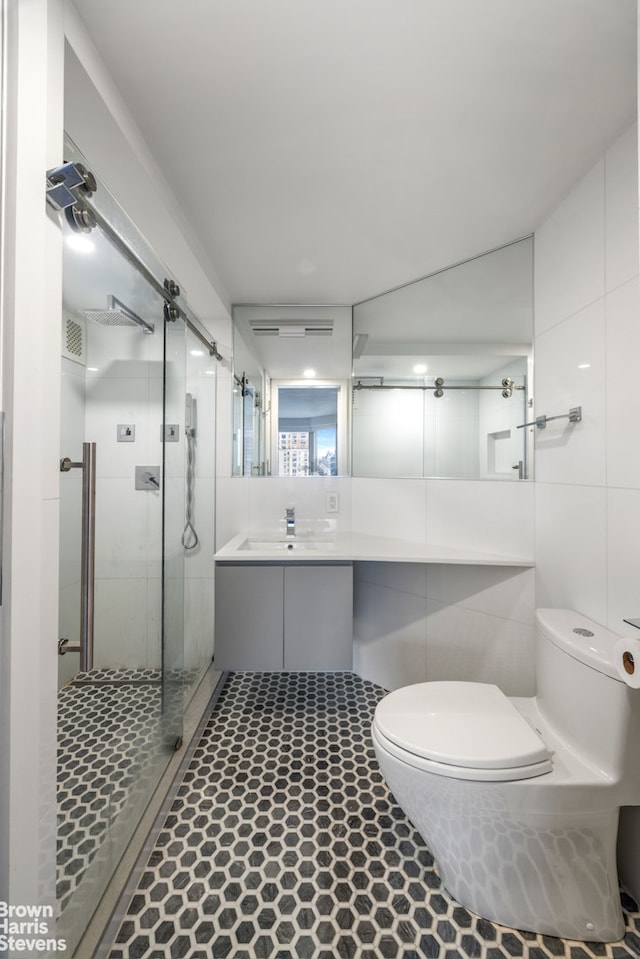 full bathroom with tile walls, a shower stall, toilet, and visible vents