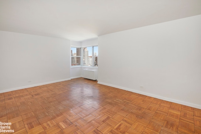 empty room featuring baseboards