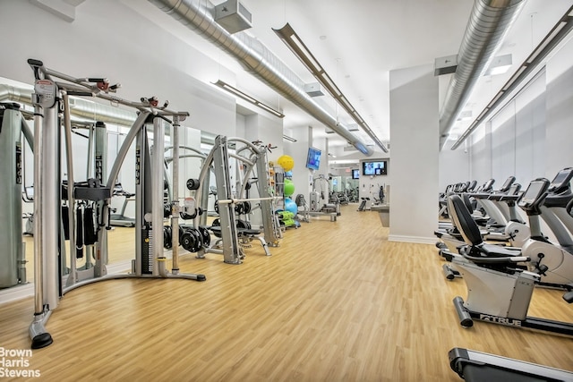 gym featuring wood finished floors and baseboards