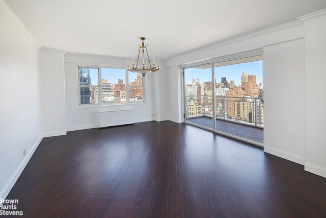unfurnished dining area featuring wood finished floors, a notable chandelier, a city view, and plenty of natural light