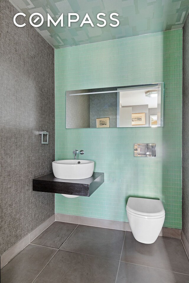 400 E 67th St Unit 12D, New York City, NY 10065 - bathroom with a sink, toilet, and tile patterned floors