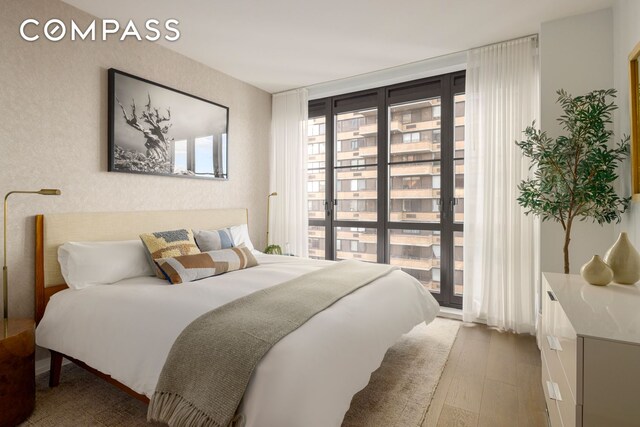 250 W 96th St Unit 11B, New York City, NY 10025 - bedroom featuring hardwood / wood-style floors and floor to ceiling windows