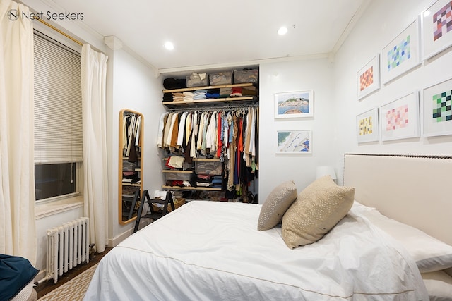 bedroom featuring crown molding, recessed lighting, wood finished floors, and radiator