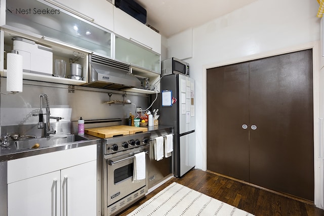 kitchen with open shelves, appliances with stainless steel finishes, a sink, stainless steel counters, and under cabinet range hood
