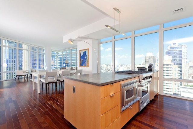 kitchen featuring visible vents, modern cabinets, stainless steel appliances, and dark wood finished floors