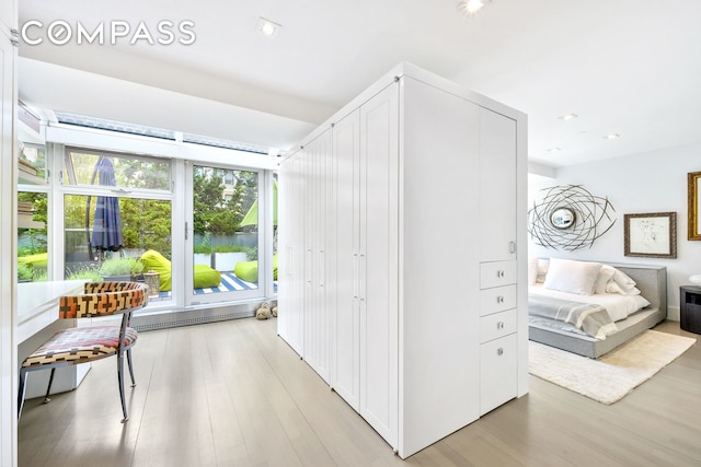 interior space featuring light wood-style floors, a water view, and recessed lighting