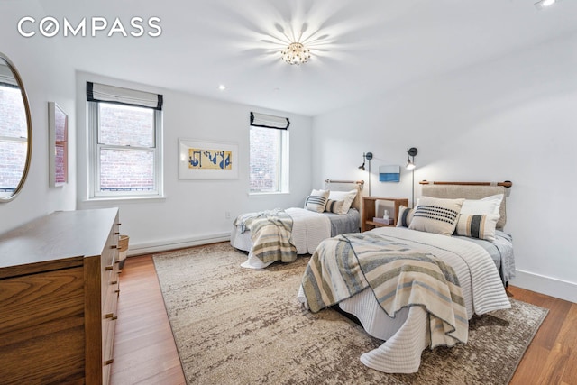 bedroom with wood finished floors and baseboards
