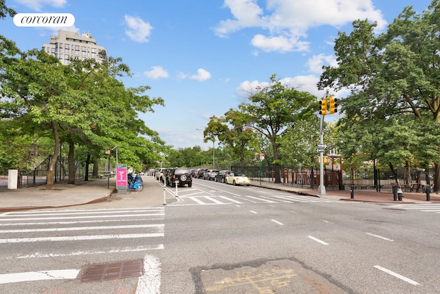 view of street with curbs, sidewalks, and traffic lights