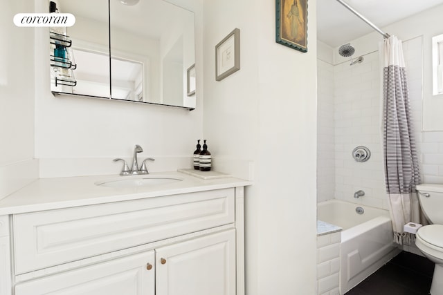 full bath with shower / tub combo, vanity, tile patterned flooring, and toilet
