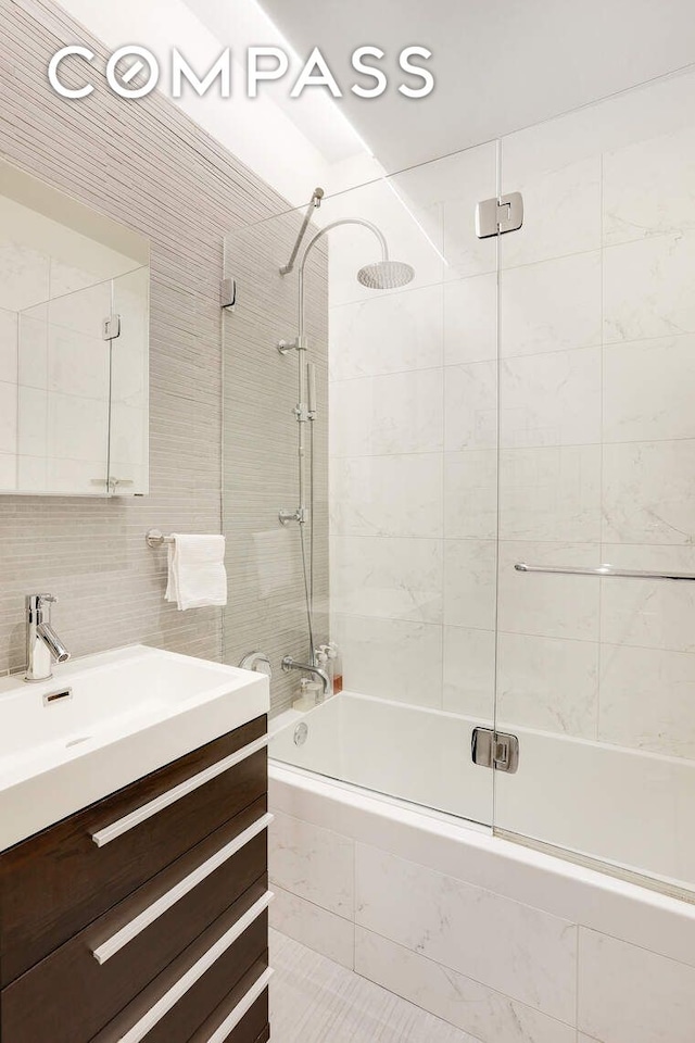 220 W 148th St Unit 3K, New York City, NY 10039 - full bathroom featuring tiled shower / bath, vanity, and tile walls