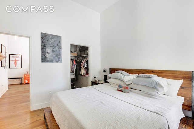 220 W 148th St Unit 3K, New York City, NY 10039 - bedroom featuring light wood finished floors, baseboards, a towering ceiling, a closet, and a spacious closet