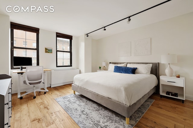 222 W 14th St Unit 3N, New York City, NY 10011 - bedroom with track lighting, light wood finished floors, and a desk