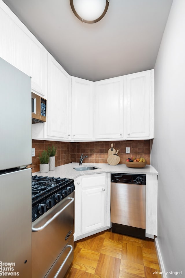 230 E 15th St Unit 5J, New York City, NY 10003 - kitchen with stainless steel appliances, white cabinets, and tasteful backsplash