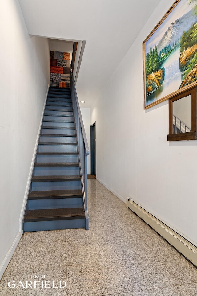stairway featuring baseboard heating and baseboards