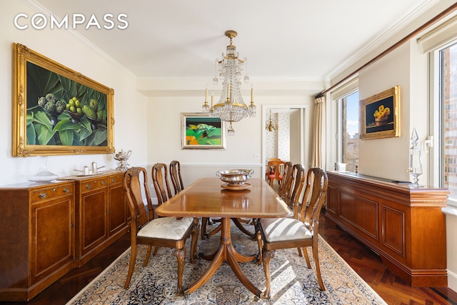dining area with ornamental molding and a chandelier