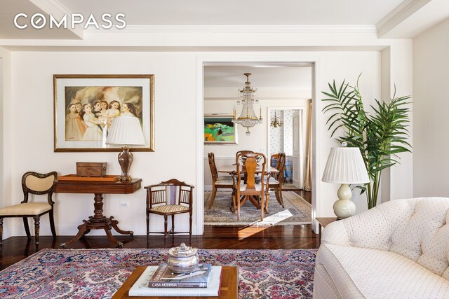 1049 5th Ave Unit 17A, New York City, NY 10028 - living room featuring crown molding, baseboards, and wood finished floors