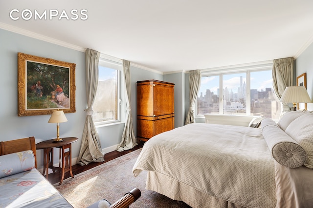 bedroom with baseboards, ornamental molding, wood finished floors, and a view of city