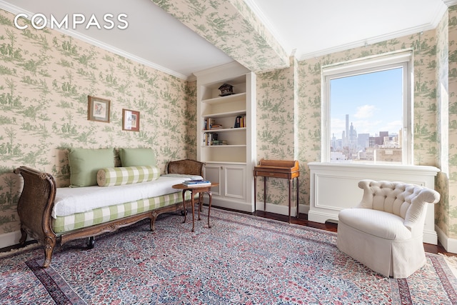 sitting room featuring a view of city, ornamental molding, wood finished floors, and wallpapered walls