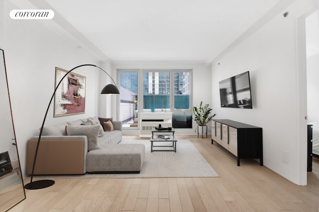 living room featuring light wood-style flooring and visible vents