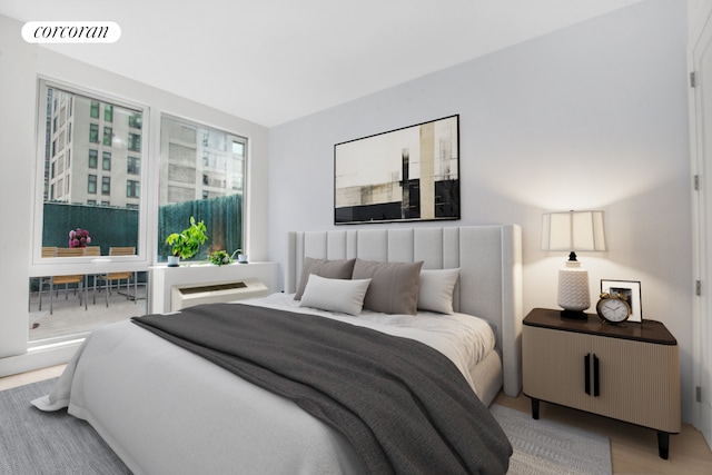 bedroom featuring wood finished floors and visible vents