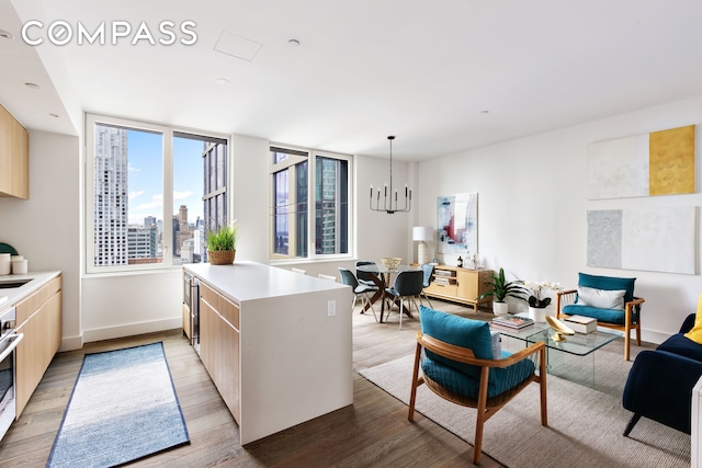 10 Nevins St Phb, Phb, New York City, NY 11217 - kitchen featuring modern cabinets, a chandelier, a peninsula, light wood-style flooring, and light countertops