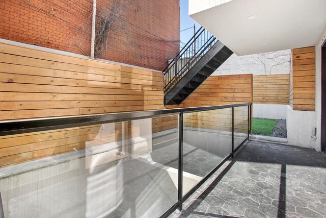 156 Devoe St Unit 1F, New York City, NY 11211 - stairs featuring a towering ceiling and wooden walls