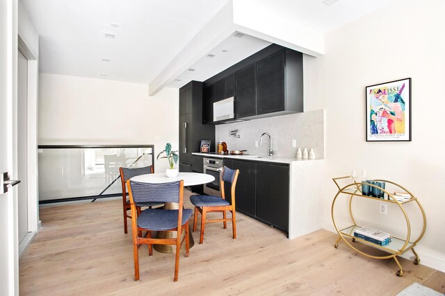 156 Devoe St Unit 1F, New York City, NY 11211 - dining room featuring light wood-style flooring and wet bar