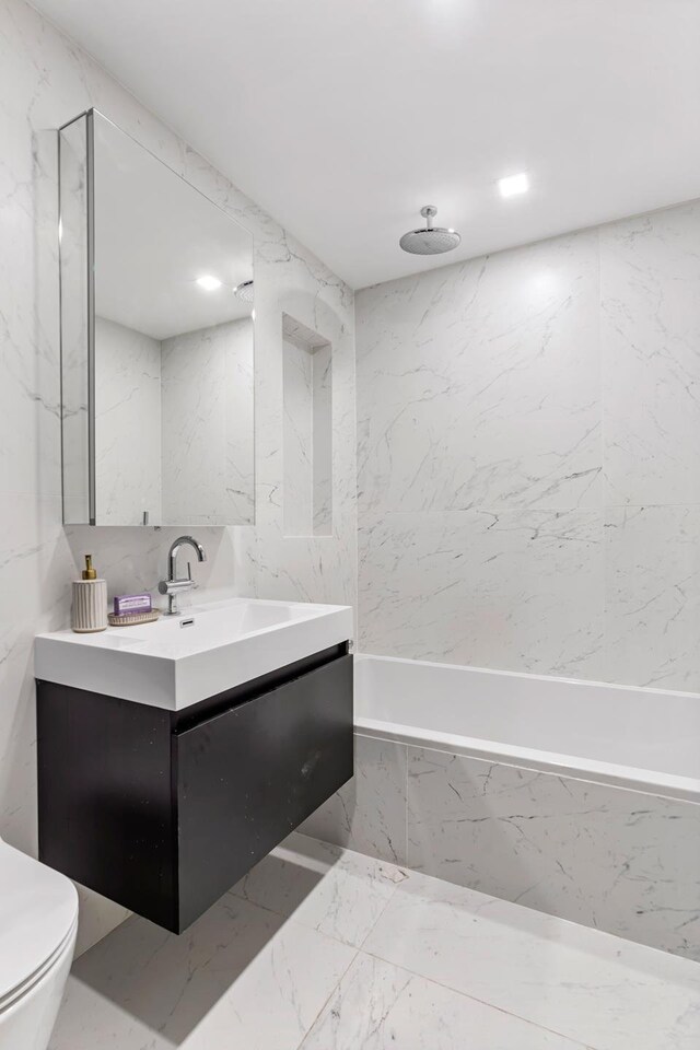 156 Devoe St Unit 1F, New York City, NY 11211 - bathroom featuring vanity, toilet, and a combined bath / shower with rainfall shower