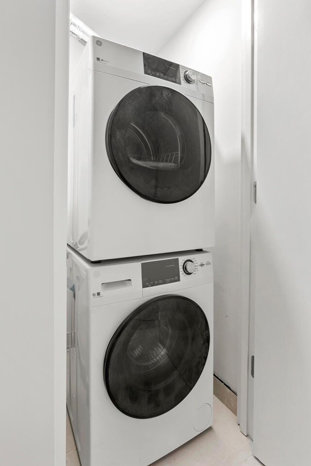 156 Devoe St Unit 1F, New York City, NY 11211 - laundry area with stacked washing machine and dryer and light tile patterned floors