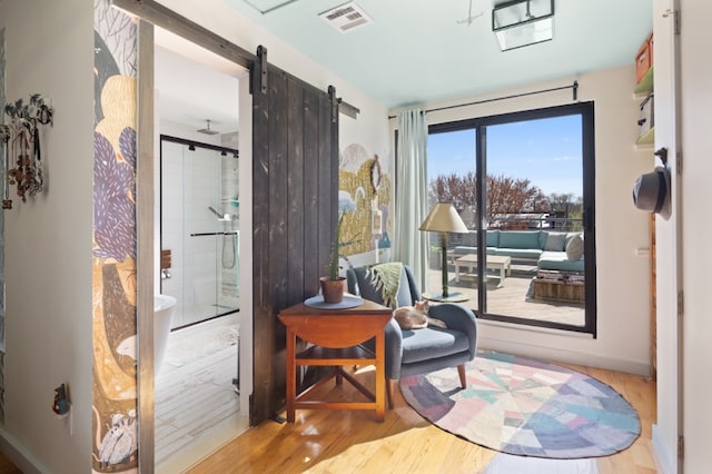 41 Wolcott Street House, New York City, NY 11231 - living area with wood finished floors, a barn door, and baseboards