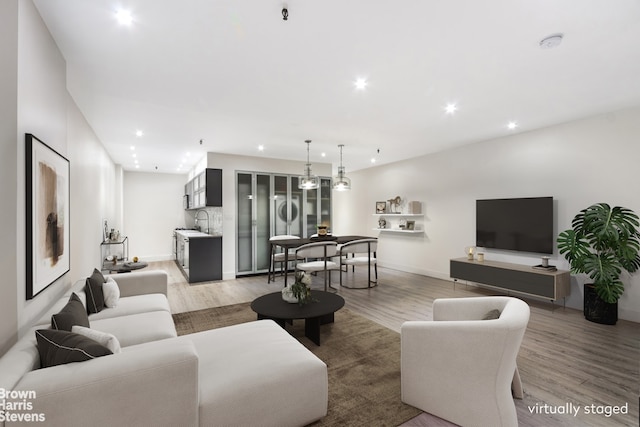 41 E 28th St Unit 2B, New York City, NY 10016 - living room featuring light wood finished floors, recessed lighting, and baseboards