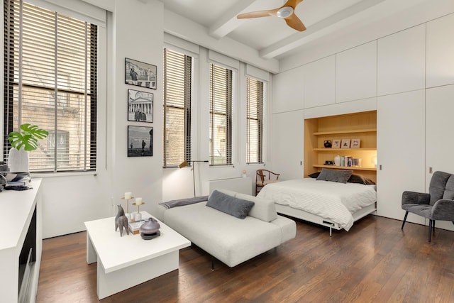 bedroom with beamed ceiling, dark wood finished floors, and ceiling fan