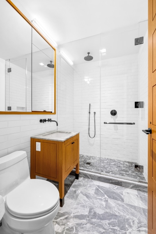 36 Bleecker St Unit 4A, New York City, NY 10012 - full bathroom featuring marble finish floors, toilet, a shower stall, and vanity