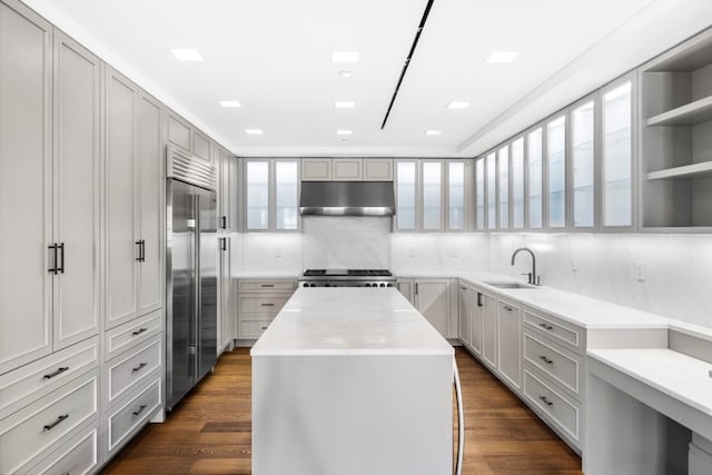 36 Bleecker St Unit 4A, New York City, NY 10012 - kitchen featuring under cabinet range hood, stainless steel built in fridge, a sink, a kitchen island, and range
