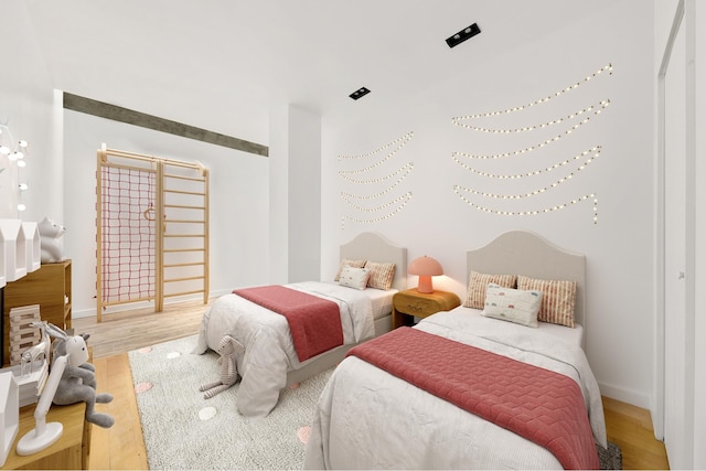 bedroom featuring wood finished floors and baseboards