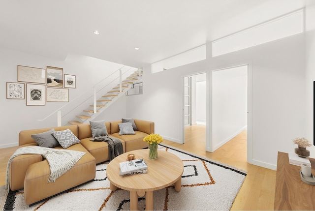 living room featuring stairway, light wood-type flooring, baseboards, and recessed lighting