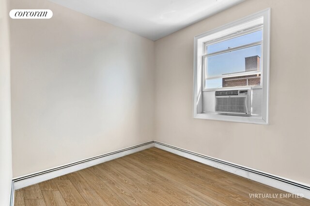 1138 Ocean Ave Unit 7G, New York City, NY 11230 - unfurnished room featuring visible vents, a baseboard radiator, wood finished floors, and cooling unit