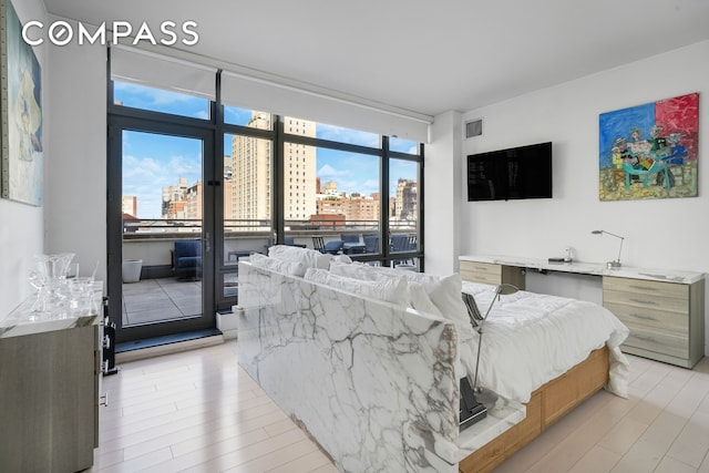 450 E 83rd St Unit 6B, New York City, NY 10028 - living room featuring light wood-type flooring and expansive windows