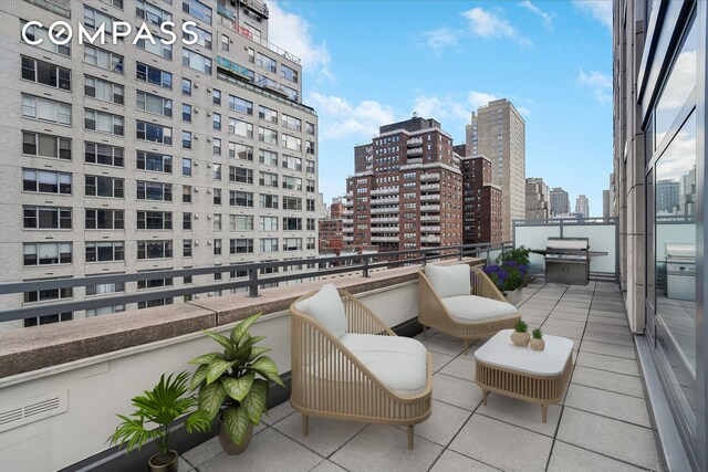 balcony featuring a view of city and a grill