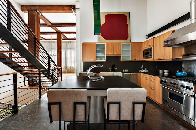 62 Beach St Tha, Unit Tha, New York City, NY 10013 - kitchen with appliances with stainless steel finishes, wall chimney range hood, decorative backsplash, a high ceiling, and a center island