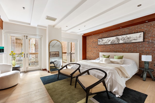 62 Beach St Tha, Unit Tha, New York City, NY 10013 - bedroom featuring access to outside, light wood-style flooring, beamed ceiling, french doors, and brick wall