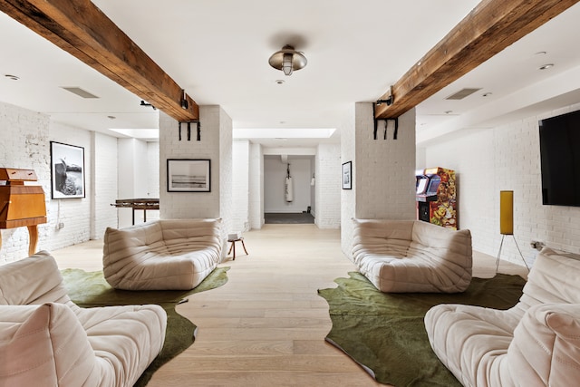 62 Beach St Tha, Unit Tha, New York City, NY 10013 - living room featuring beamed ceiling, brick wall, and wood finished floors