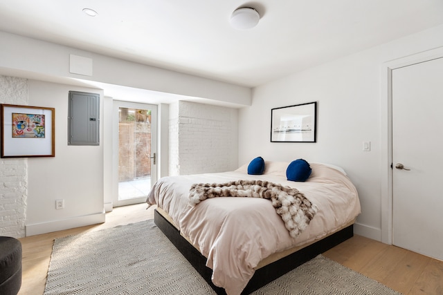 62 Beach St Tha, Unit Tha, New York City, NY 10013 - bedroom with electric panel, access to exterior, light wood finished floors, and baseboards